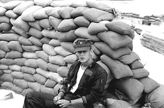 A Pilot Sits Near a Bunker