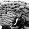 A Pilot Sits Near a Bunker