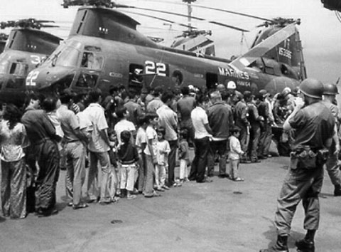 A line of refugees on the flight deck of a carrier