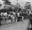 A line of refugees on the flight deck of a carrier